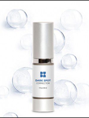 A bottle of dark spot corrector on top of a white background.