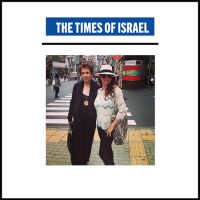 Two women standing on a street with the times of israel logo.